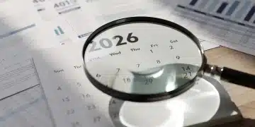 Calendar 2026 with financial documents, symbolizing retirement planning and contribution changes.