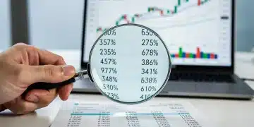 Hand with magnifying glass examining investment fees on a financial statement, symbolizing detailed financial analysis and cost reduction.